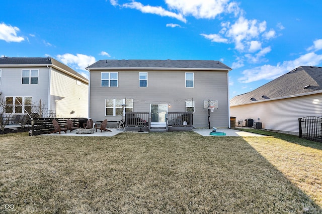 rear view of house with a yard, central AC unit, an outdoor fire pit, and a patio