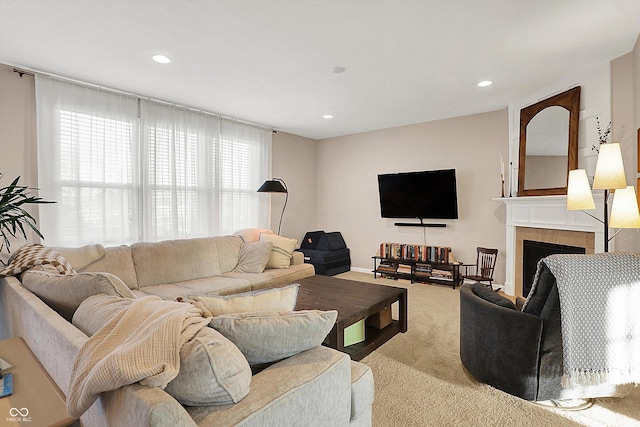 carpeted living room with recessed lighting and a tiled fireplace