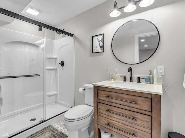 full bath with a stall shower, toilet, and vanity