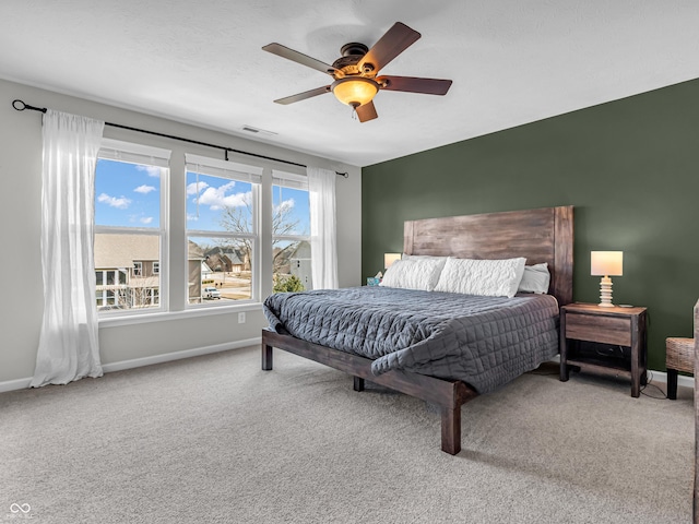 bedroom with visible vents, ceiling fan, baseboards, and carpet floors