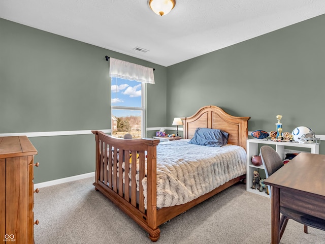 bedroom with visible vents, baseboards, and carpet