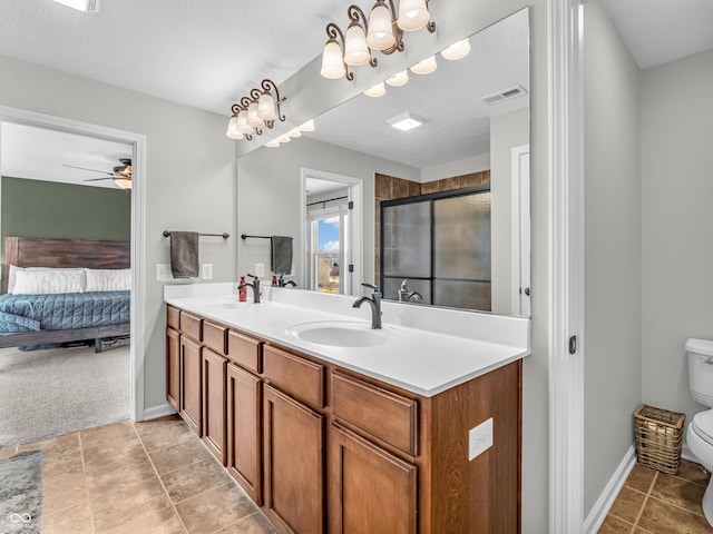 full bathroom with a shower stall, toilet, visible vents, and a sink