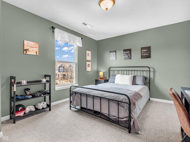 carpeted bedroom with baseboards and visible vents