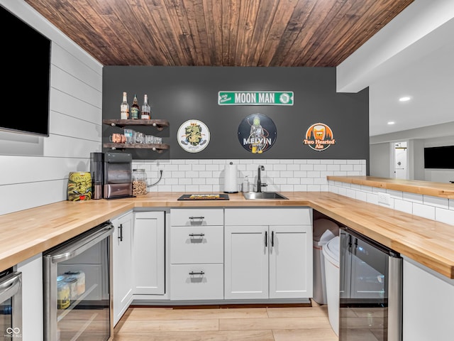 bar with wet bar, wooden ceiling, beverage cooler, and a sink