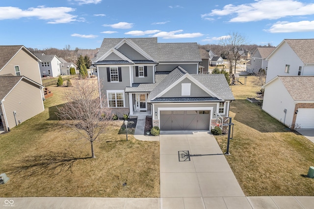 traditional home with driveway, a residential view, a front yard, a shingled roof, and a garage