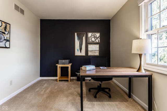 carpeted home office with visible vents and baseboards