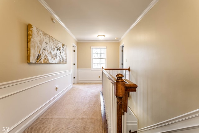 hall featuring crown molding, an upstairs landing, wainscoting, and light carpet