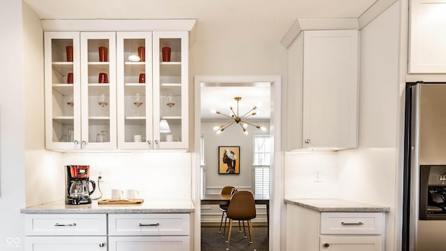 interior space with tasteful backsplash and stainless steel fridge with ice dispenser