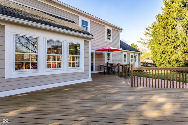 wooden terrace with outdoor dining space