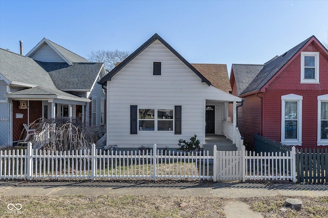 bungalow-style home featuring a fenced front yard and a porch