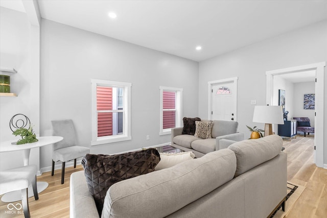 living area featuring recessed lighting, light wood-style floors, and baseboards