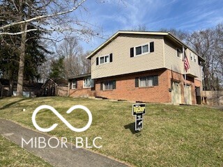 view of side of property with a lawn and an attached garage