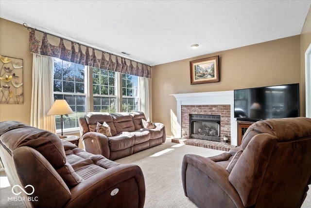 living room featuring carpet flooring, a fireplace, visible vents, and a textured ceiling