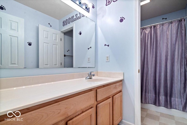 full bath with vanity, tile patterned floors, and curtained shower