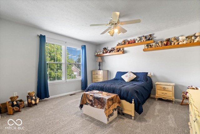 bedroom with visible vents, carpet flooring, a textured ceiling, and baseboards