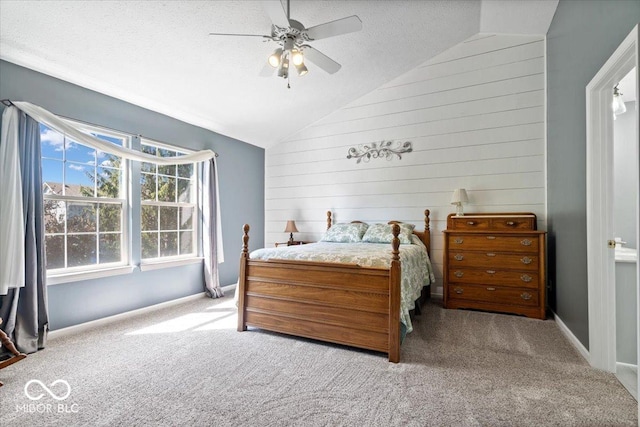 bedroom featuring baseboards, lofted ceiling, carpet flooring, a textured ceiling, and a ceiling fan