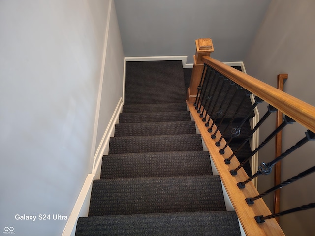 staircase featuring baseboards