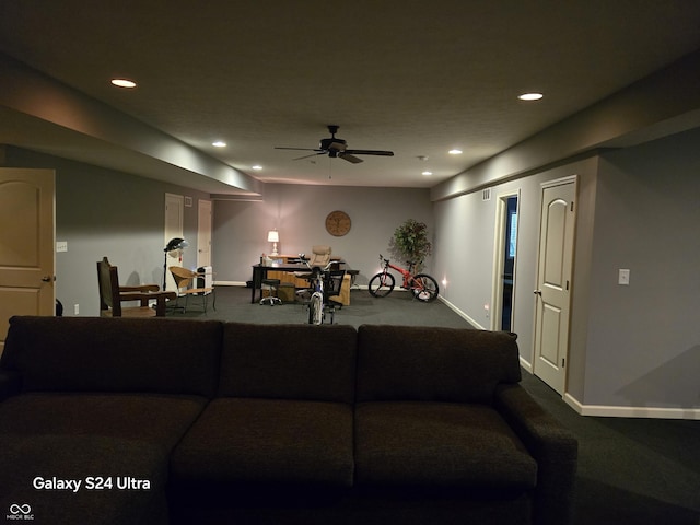living room with recessed lighting, dark colored carpet, and baseboards