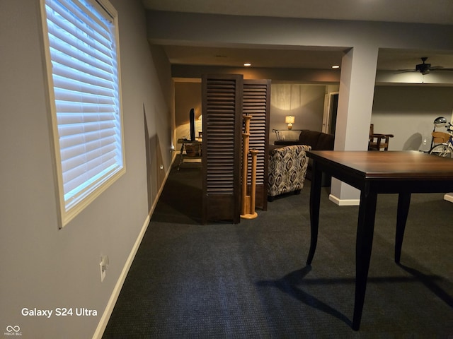 hall with a wealth of natural light, carpet flooring, and baseboards