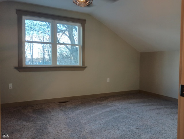 5603 S Randolph St, Indianapolis, IN 46227 - additional living space featuring baseboards, visible vents, carpet floors, and vaulted ceiling