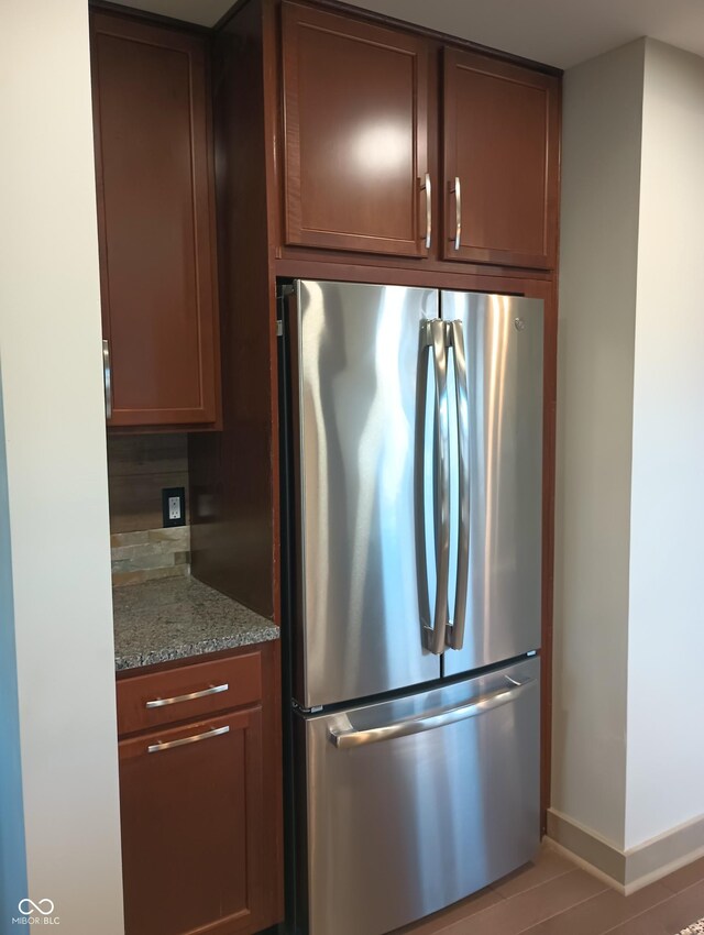 5603 S Randolph St, Indianapolis, IN 46227 - kitchen with freestanding refrigerator, light stone countertops, and baseboards