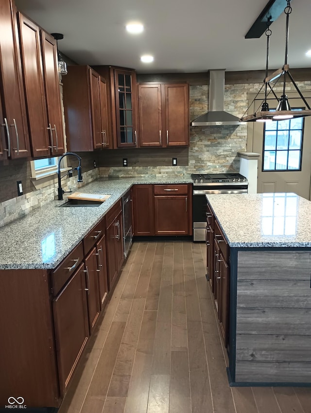 5603 S Randolph St, Indianapolis, IN 46227 - kitchen with glass insert cabinets, a sink, wall chimney exhaust hood, stainless steel range with gas stovetop, and tasteful backsplash