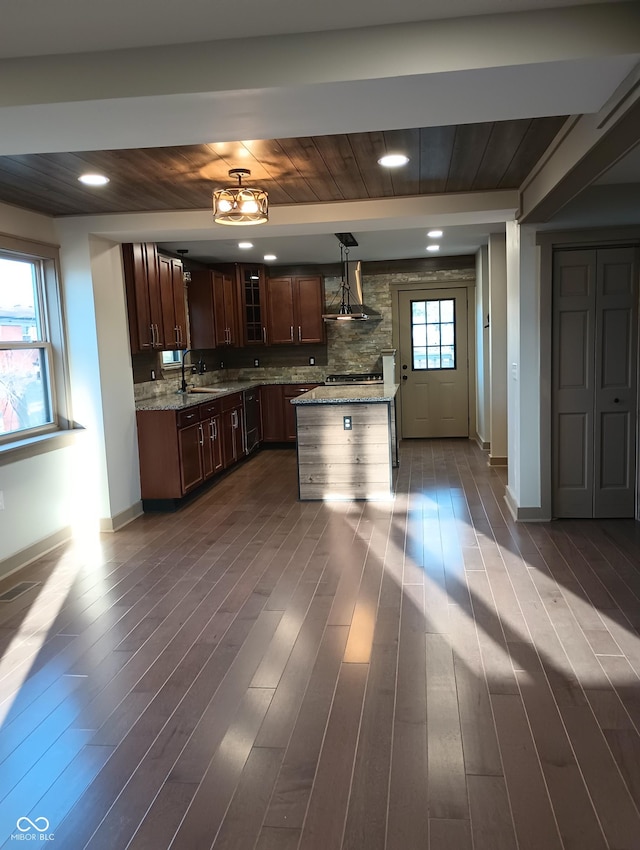 5603 S Randolph St, Indianapolis, IN 46227 - kitchen with light stone countertops, glass insert cabinets, baseboards, a sink, and wall chimney exhaust hood