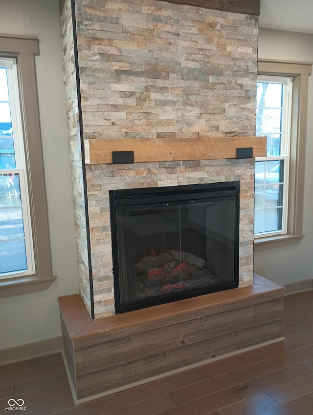 5603 S Randolph St, Indianapolis, IN 46227 - room details with baseboards, a fireplace, and wood finished floors