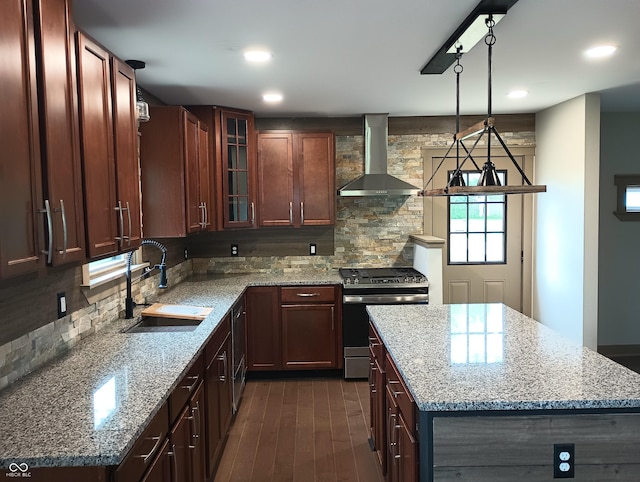 5603 S Randolph St, Indianapolis, IN 46227 - kitchen featuring wall chimney range hood, tasteful backsplash, stainless steel range with gas cooktop, and a sink