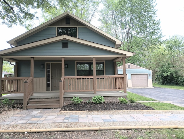 5603 S Randolph St, Indianapolis, IN 46227 - view of front facade with an outbuilding, aphalt driveway, covered porch, and a garage