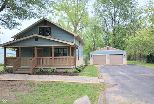 5603 S Randolph St, Indianapolis, IN 46227 - bungalow-style house with covered porch, an outdoor structure, a garage, and a front lawn