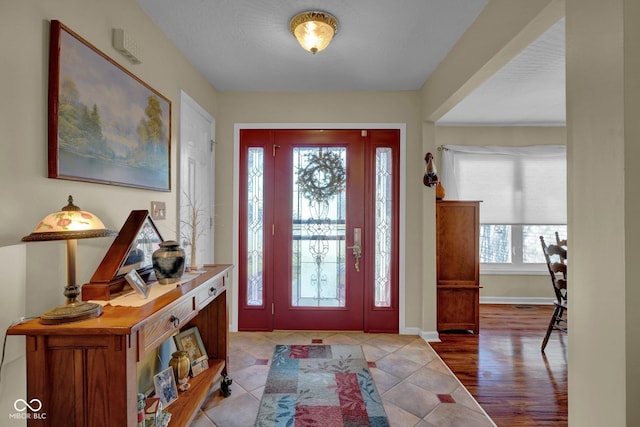 entryway featuring tile patterned floors and baseboards