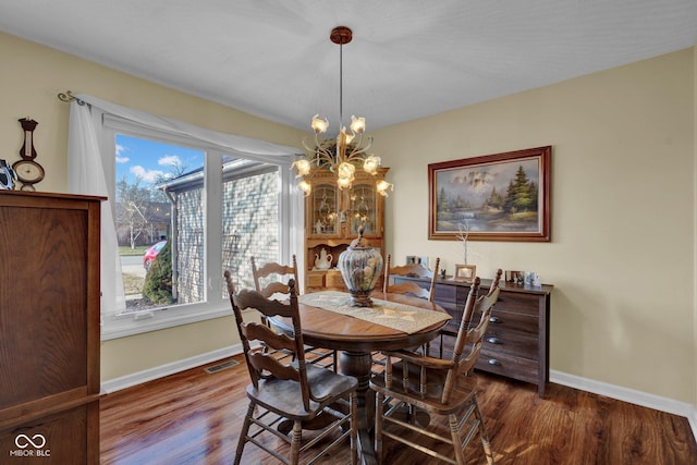 dining space featuring visible vents, baseboards, and dark wood-style flooring