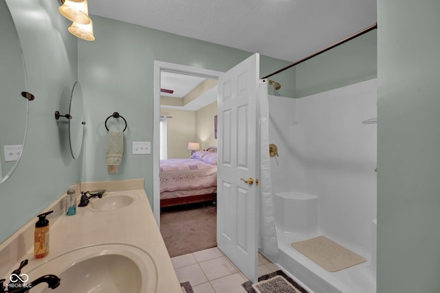 full bath with tile patterned floors, curtained shower, and a sink