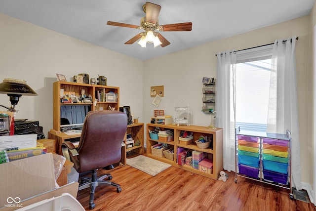 office space featuring wood finished floors and ceiling fan