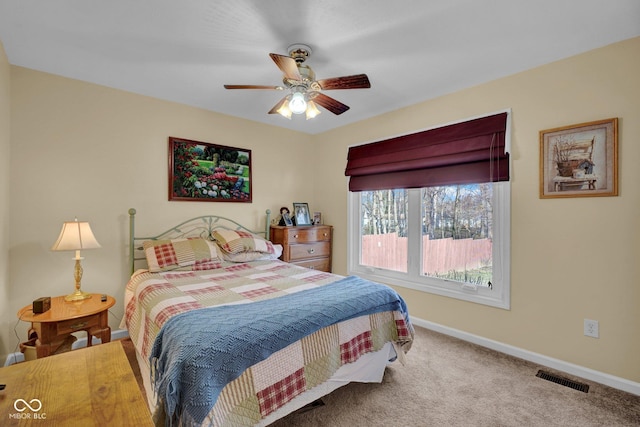 bedroom featuring visible vents, carpet floors, baseboards, and a ceiling fan