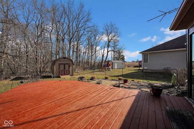 deck featuring an outbuilding, a storage shed, and a lawn