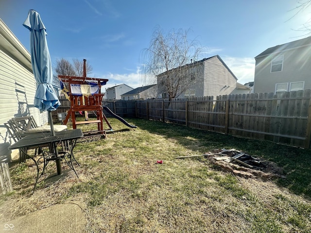 view of yard with a playground and a fenced backyard