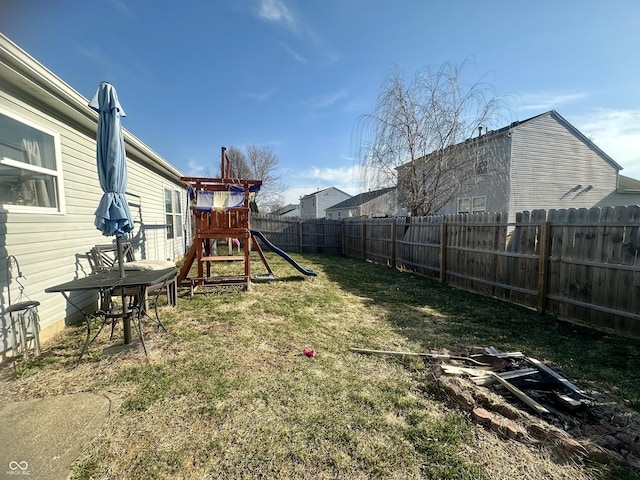 view of yard with a playground and a fenced backyard