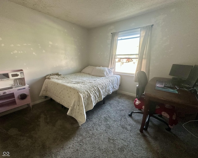 bedroom with carpet, baseboards, and a textured ceiling