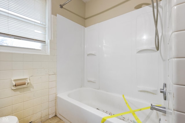 full bathroom with shower / bath combination and tile walls