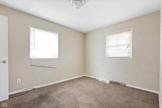 carpeted empty room with plenty of natural light and baseboards