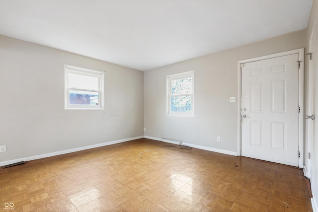 spare room featuring visible vents and baseboards