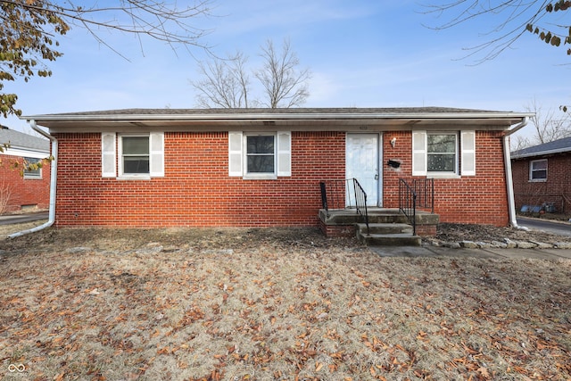 view of front of house with brick siding and a shingled roof