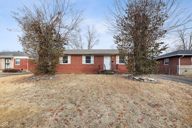 ranch-style house with brick siding and a front yard