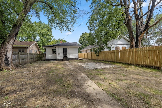 view of yard featuring a fenced backyard and entry steps