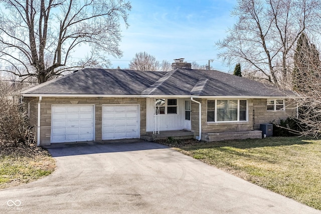 ranch-style house with stone siding, a front lawn, roof with shingles, and a chimney