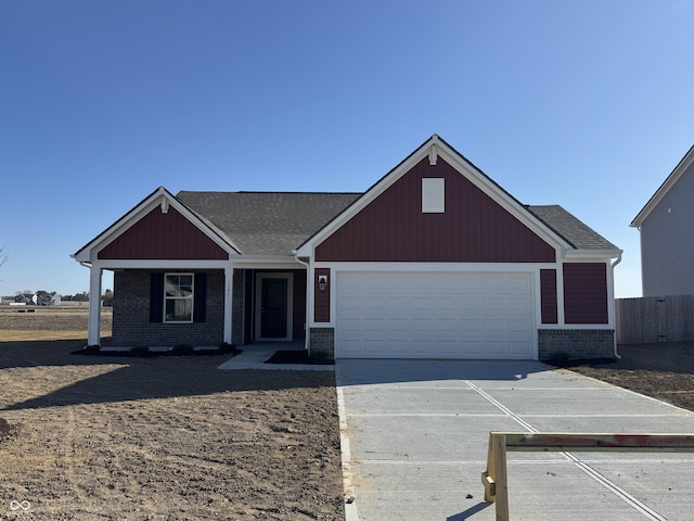 view of front of property with brick siding, an attached garage, fence, roof with shingles, and driveway