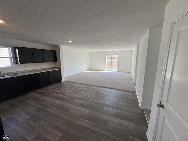 interior space featuring plenty of natural light, dark wood-style floors, baseboards, and a sink