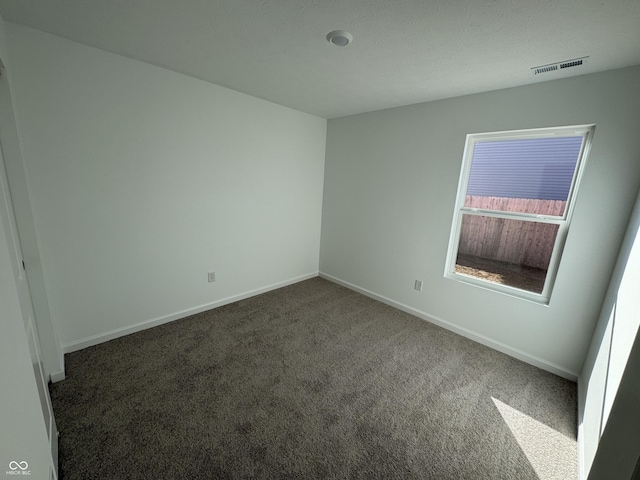 unfurnished room featuring visible vents, baseboards, and carpet floors